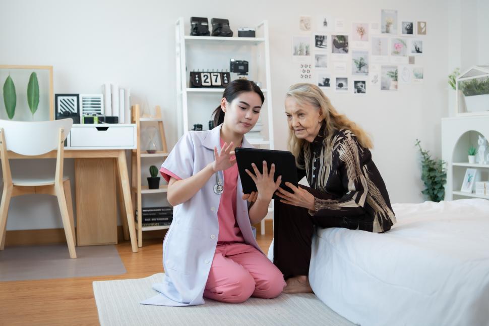 Healthcare professional with patient using tablet