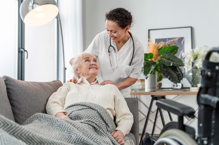 Nurse caring for elderly patient at home
