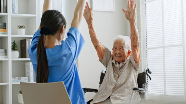 Physical therapist working with elderly patient